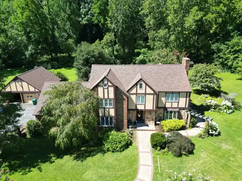 Asphalt shingle roof on a Tudor-style home — completed by Palisade Roofing in East Tennessee.