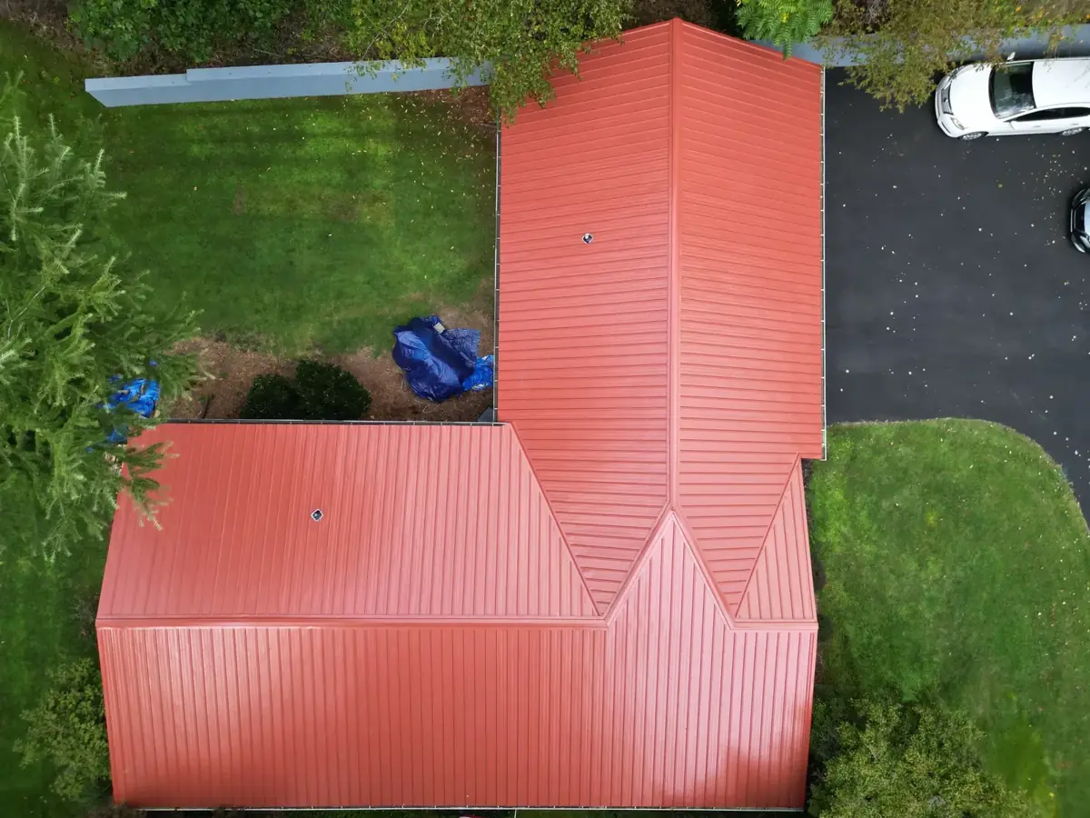 Rustic red standing-seam metal roof on a Tri-Cities home — a Palisade Roofing installation.