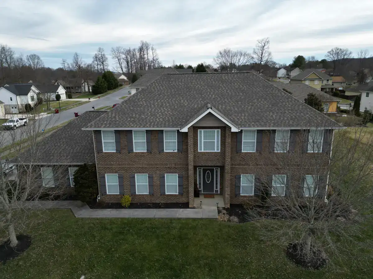 Weathered Shadow architectural shingles on a brick colonial — completed by Palisade Roofing in the Tri-Cities.