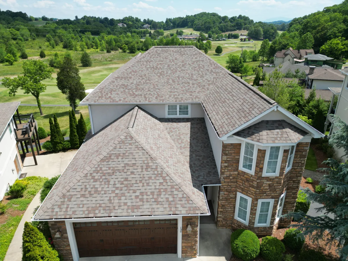 Weathered Wood architectural shingles on a stone-and-brick Tri-Cities home — completed by Palisade Roofing.