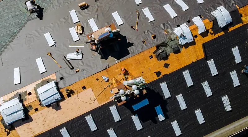 A Palisade Roofing crew completing a full asphalt shingle tear-off and replacement on a residential home.